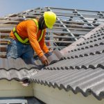 Roof,repair,,worker,with,white,gloves,replacing,gray,tiles,or