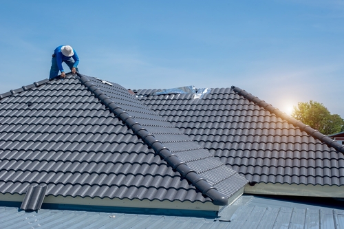 Roofer,at,work,,installing,clay,roof,tiles,construction,roofer,installing,roof