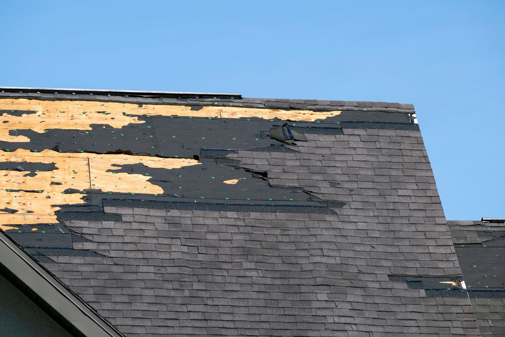 Consequences,of,natural,disaster.,damaged,house,roof,with,missing,shingles